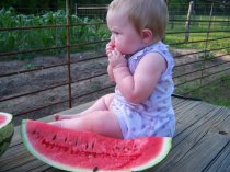 My daughter Addie, enjoying a watermelon that I didn't grow.